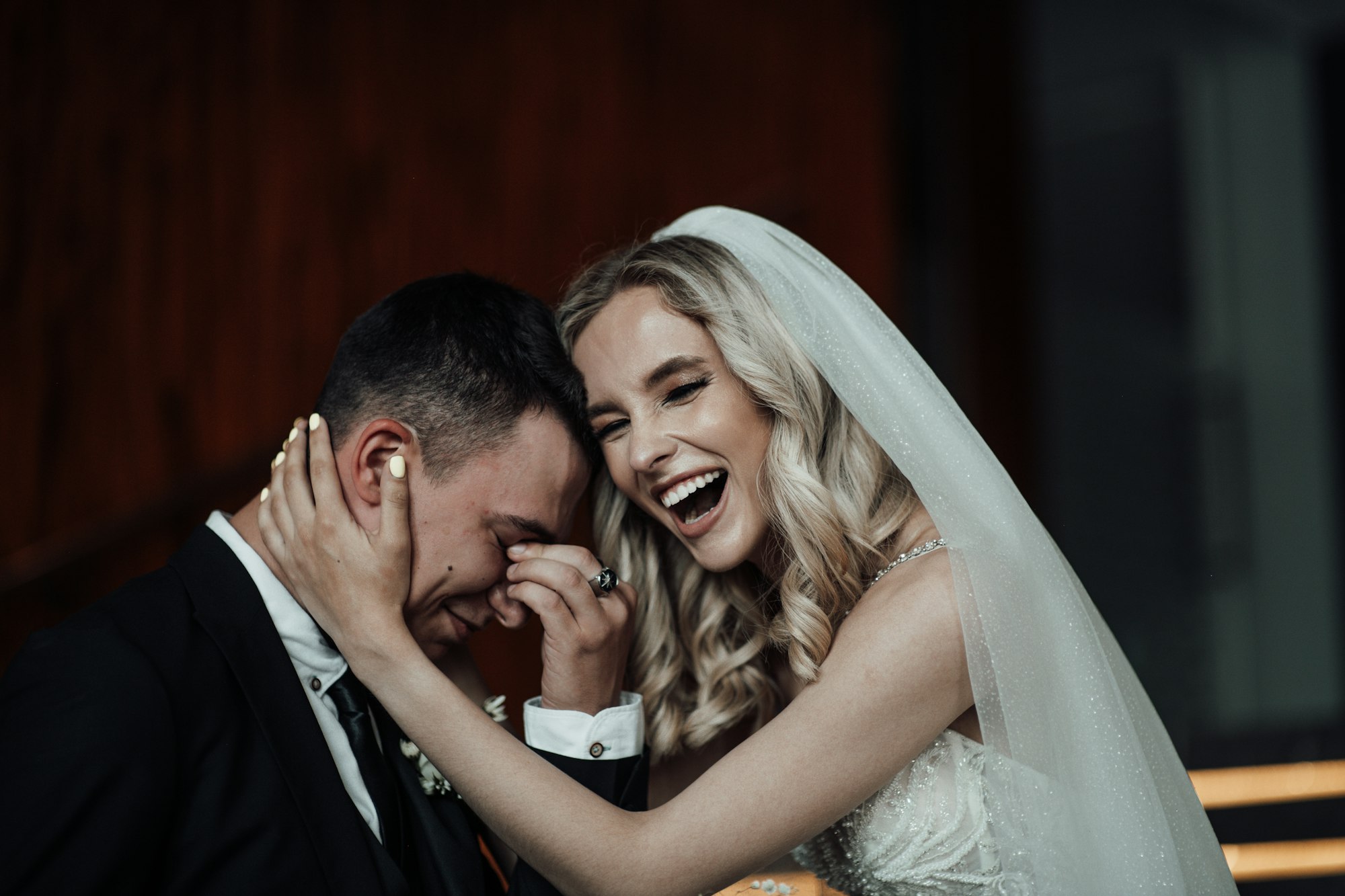 lachende Braut hält ihren Bräutigam auf ihrer Hochzeit und nach der freien Trauung in Regensburg von Evylin als Traurednerin