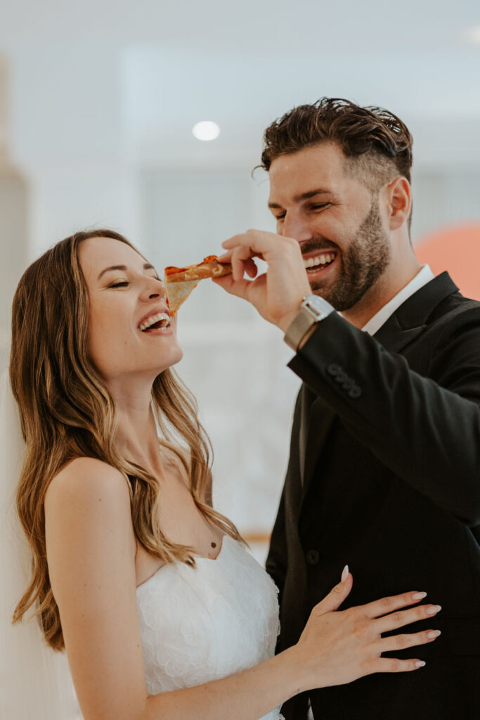 Braut und Bräutigam füttern sich mit Pizza nach Trauung mit Evylin bei ihrer Micro wedding